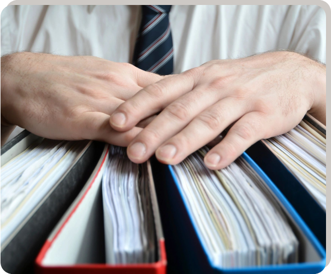 A person in a tie is holding some papers